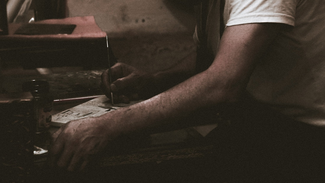 man writing on paper
