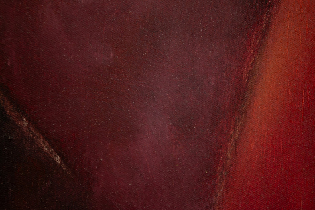 a close up of a red and black painting