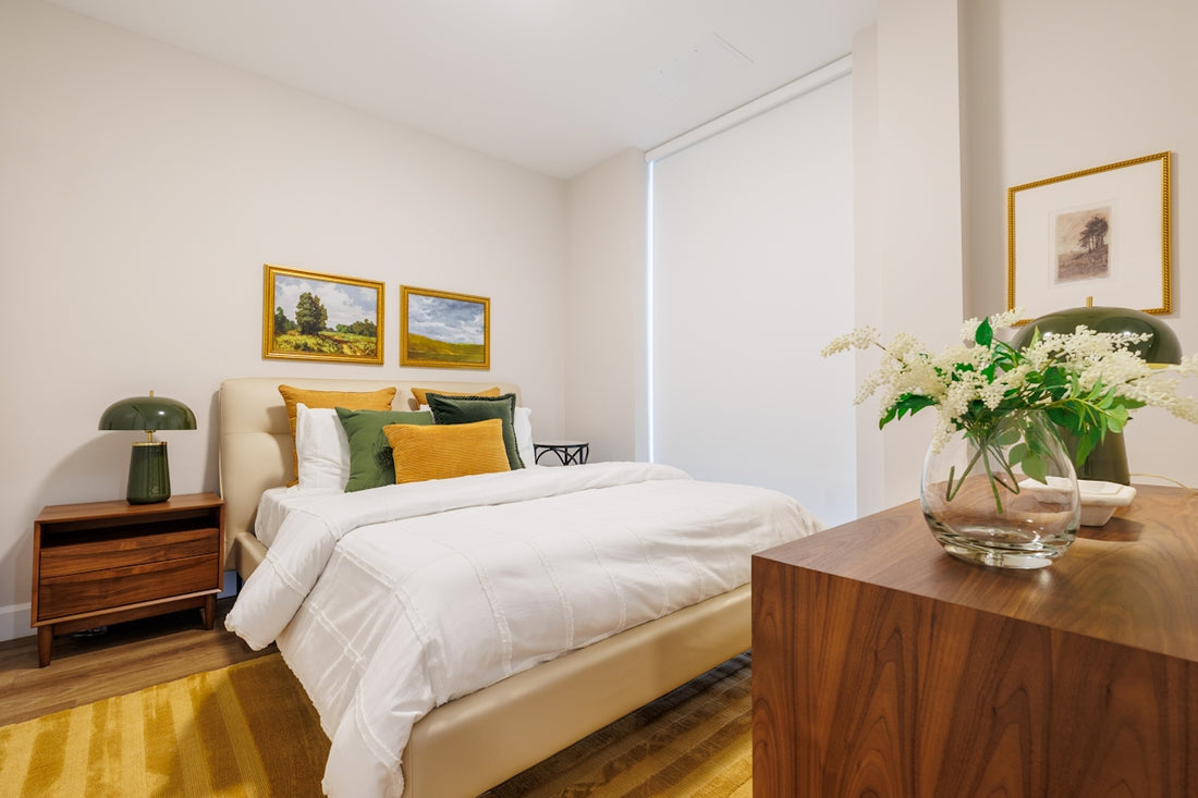 A modern bedroom with a bed and artwork.